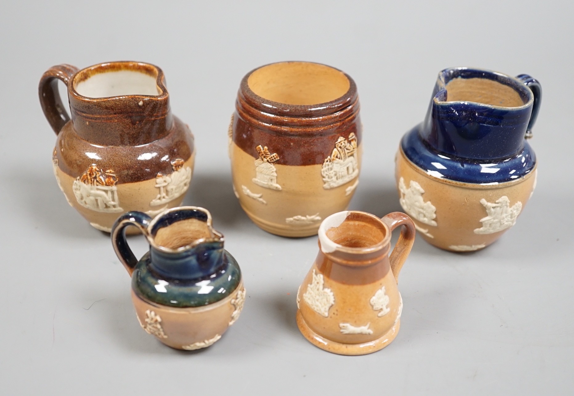 A large collection of brown stoneware miniature vessels, mostly Doulton